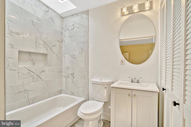 bathroom with vanity, toilet, and a skylight