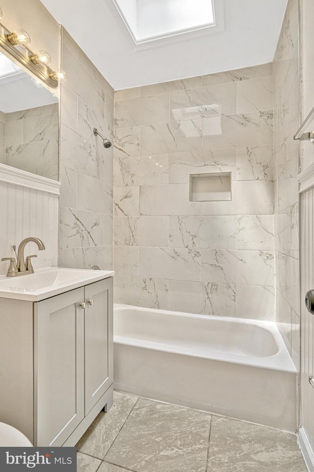 bathroom featuring vanity and tiled shower / bath