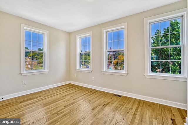 spare room with light wood-type flooring