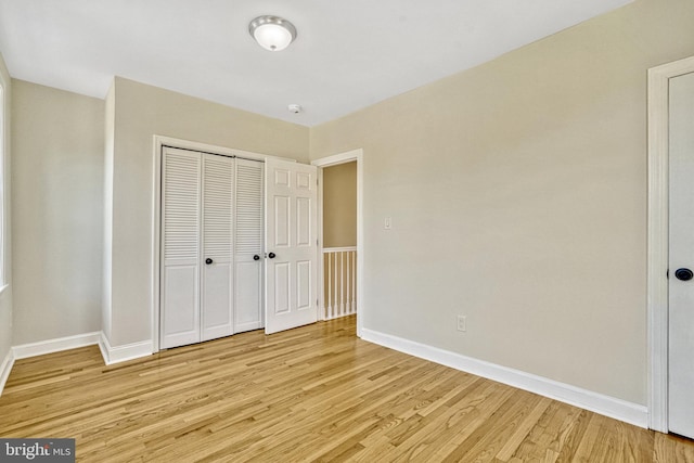 unfurnished bedroom featuring a closet and light hardwood / wood-style floors