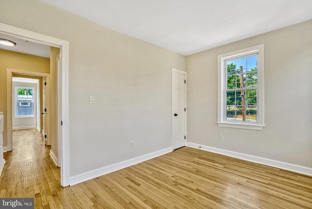 unfurnished room featuring a healthy amount of sunlight and light hardwood / wood-style flooring