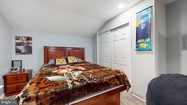 carpeted bedroom featuring vaulted ceiling and a closet