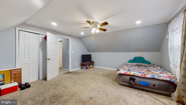 bedroom featuring carpet floors, a closet, ceiling fan, and vaulted ceiling