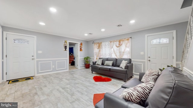 living room featuring ornamental molding and light wood-type flooring