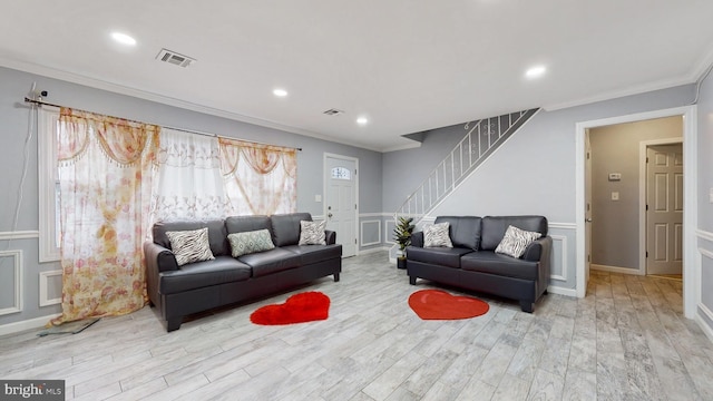 living room featuring light hardwood / wood-style flooring and ornamental molding