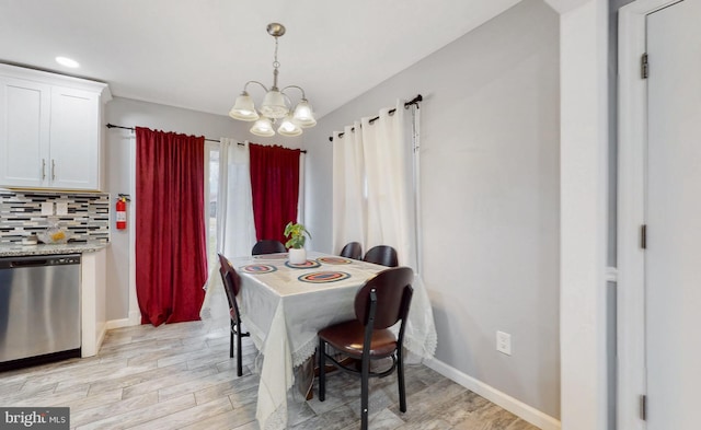 dining space with a notable chandelier and light wood-type flooring