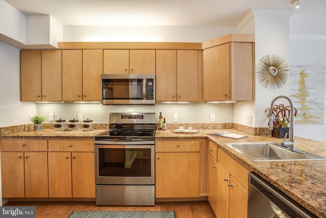 kitchen featuring tasteful backsplash, appliances with stainless steel finishes, light brown cabinetry, and sink