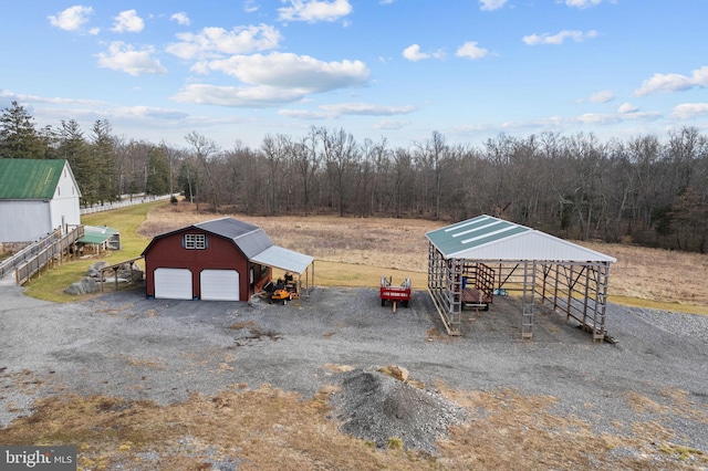 exterior space featuring a garage and a rural view