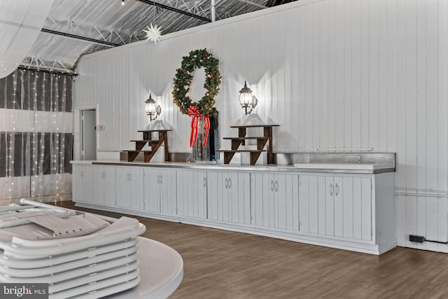 living area with hardwood / wood-style floors and a high ceiling