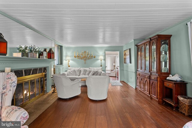 living room with wood-type flooring, crown molding, and a premium fireplace