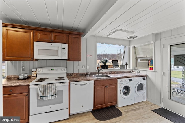 kitchen featuring a healthy amount of sunlight, light wood-type flooring, and white appliances