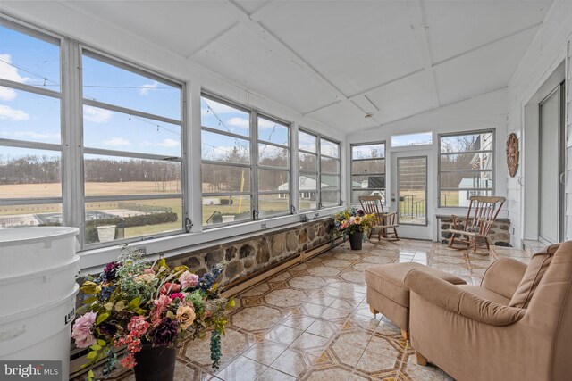 sunroom featuring vaulted ceiling