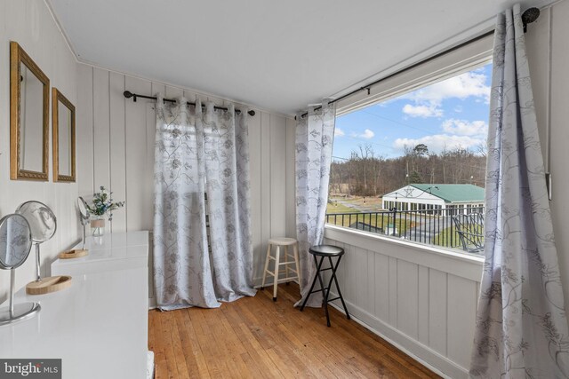 living area featuring plenty of natural light and hardwood / wood-style flooring