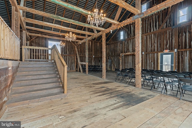 interior space with a high ceiling, a chandelier, and hardwood / wood-style floors