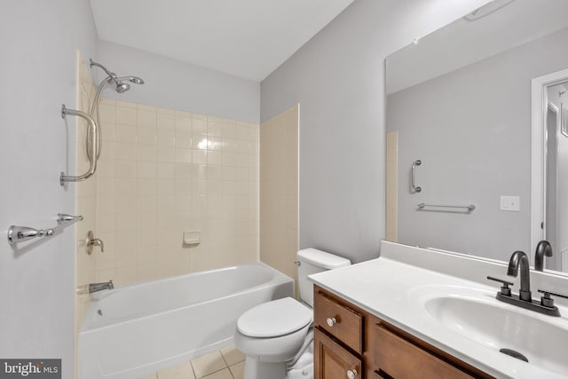 full bathroom featuring tile patterned floors, tiled shower / bath combo, vanity, and toilet