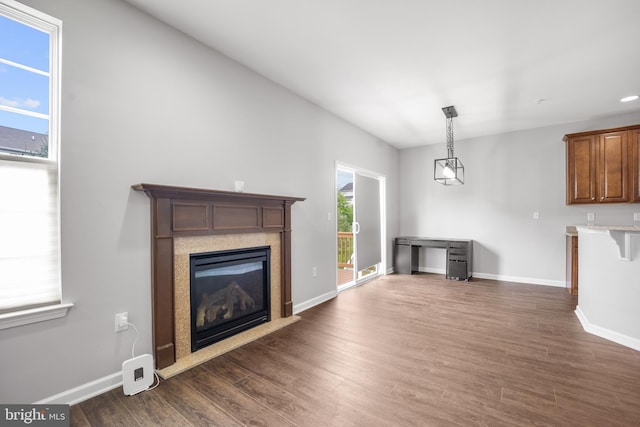 unfurnished living room with dark hardwood / wood-style flooring