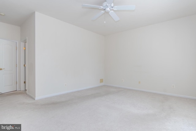 spare room with light colored carpet and ceiling fan