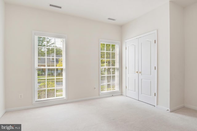 carpeted spare room with a wealth of natural light