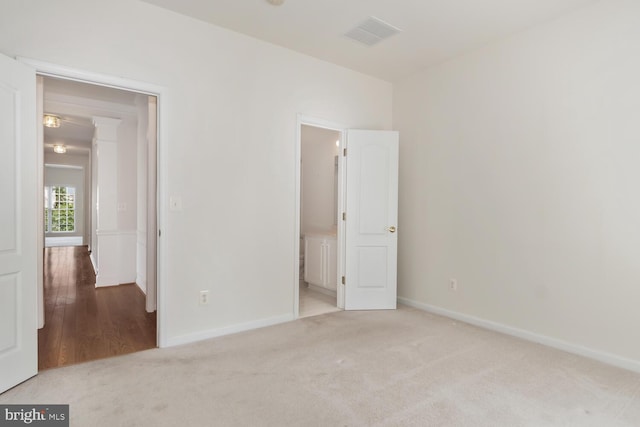 empty room featuring light carpet