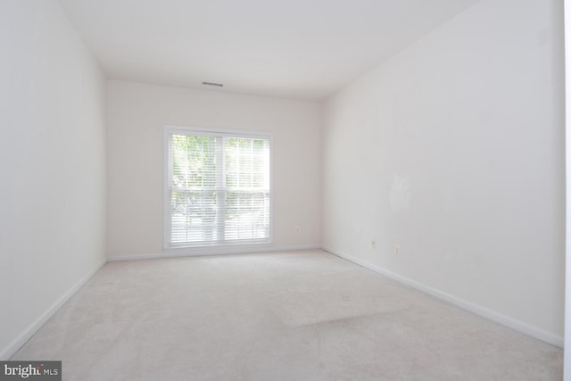 empty room with light colored carpet