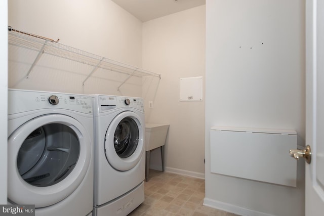 clothes washing area featuring washing machine and dryer