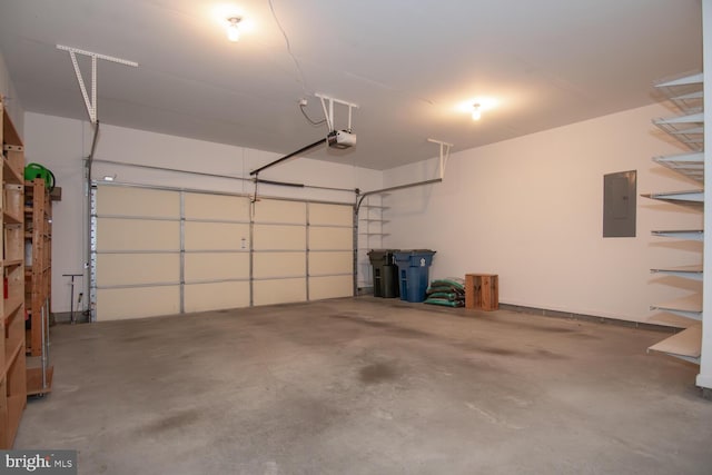 garage with a garage door opener and electric panel