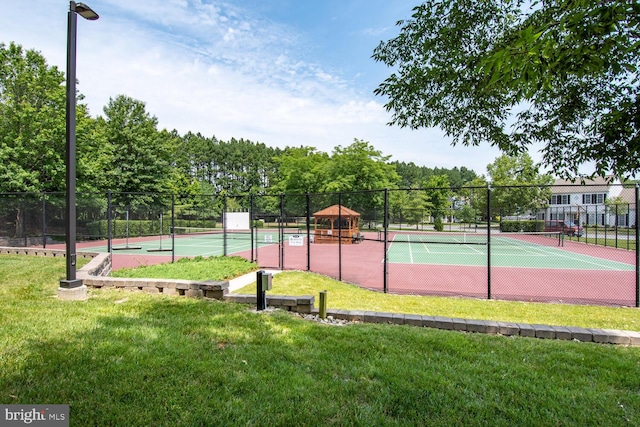 view of sport court featuring a lawn