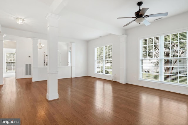 unfurnished living room featuring dark hardwood / wood-style flooring, decorative columns, and ceiling fan