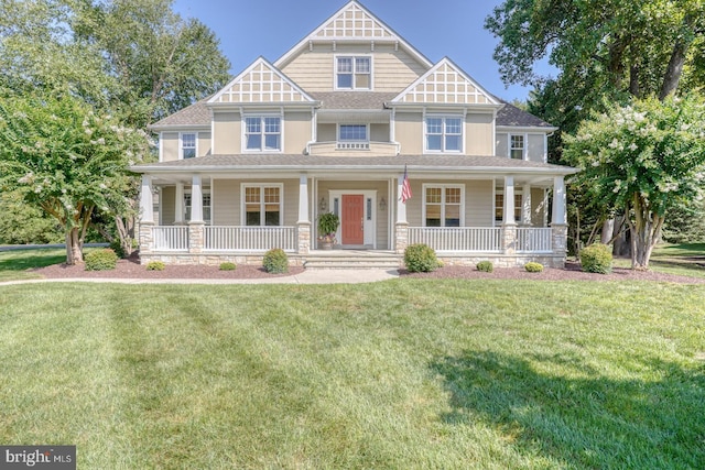 view of front of home with a porch and a front lawn