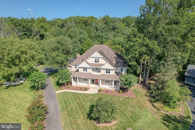 birds eye view of property with a forest view