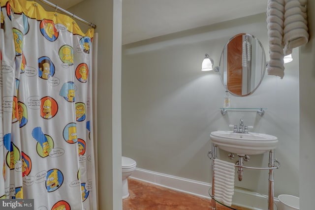 bathroom featuring sink, curtained shower, tile patterned floors, and toilet