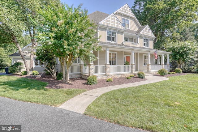 view of front of home with a porch and a front lawn