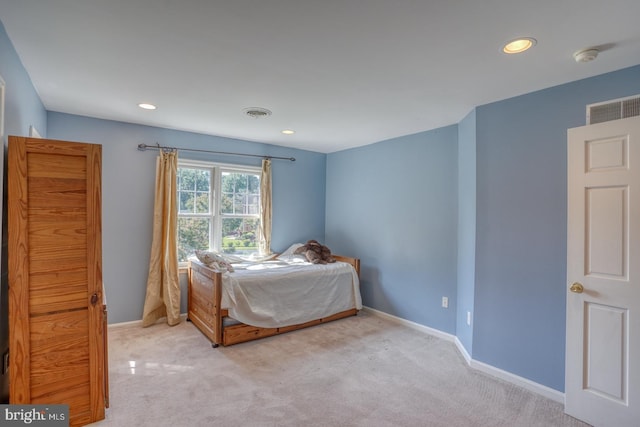 bedroom featuring baseboards, recessed lighting, visible vents, and light colored carpet