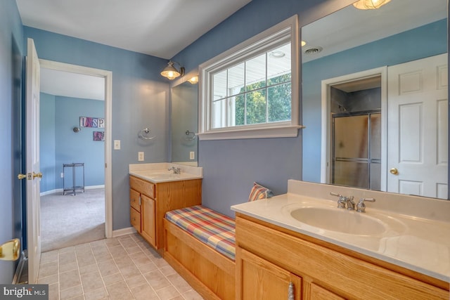 full bathroom featuring visible vents, a shower with door, a sink, tile patterned flooring, and two vanities