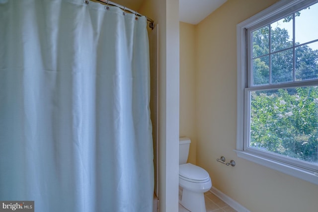 bathroom with toilet and tile patterned floors