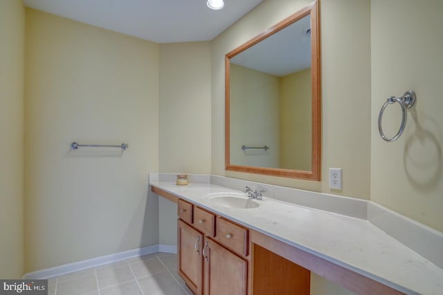 bathroom with tile patterned flooring, vanity, and baseboards