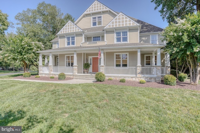 craftsman-style house featuring covered porch and a front lawn