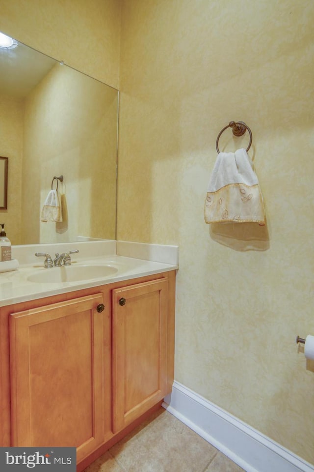 bathroom with tile patterned flooring, vanity, and baseboards