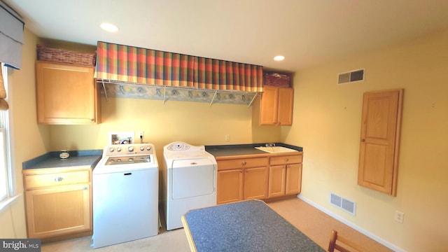 clothes washing area featuring washing machine and dryer, visible vents, cabinet space, and recessed lighting