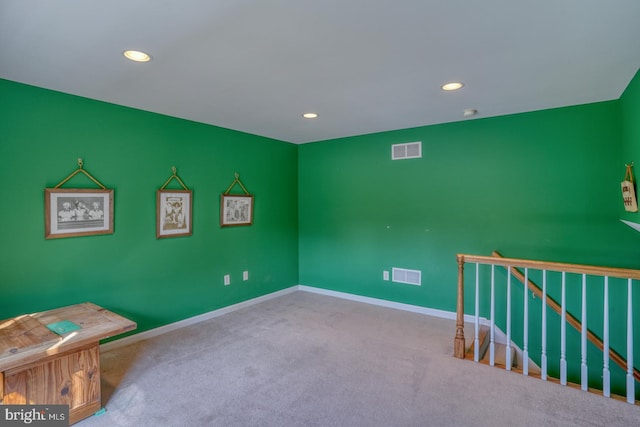 interior space with carpet floors, baseboards, visible vents, and recessed lighting