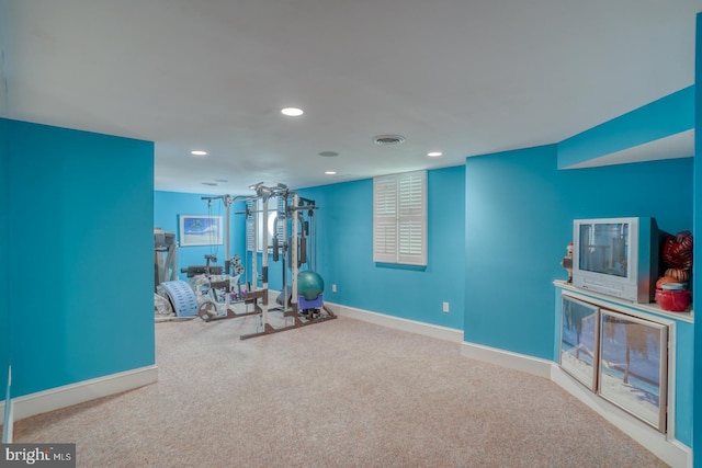 exercise area featuring visible vents, baseboards, carpet flooring, and recessed lighting