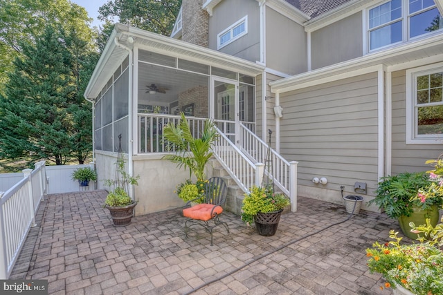 exterior space featuring a sunroom, a patio area, and a fenced backyard