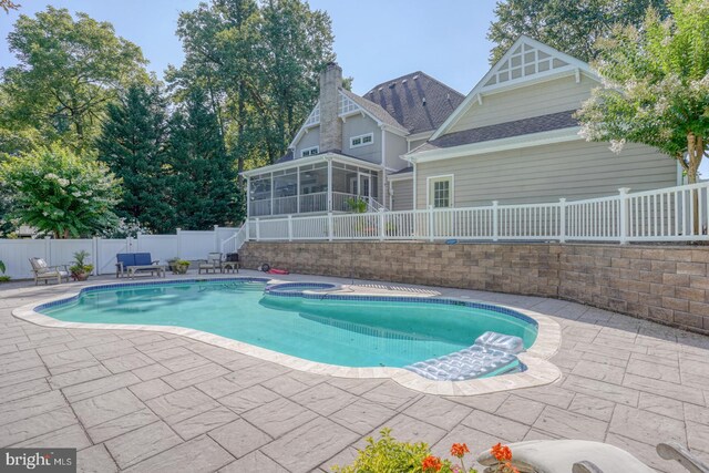 rear view of house with central AC, a fenced in pool, a patio area, and a sunroom