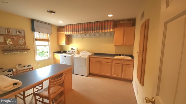 laundry room featuring cabinets, sink, and washing machine and dryer