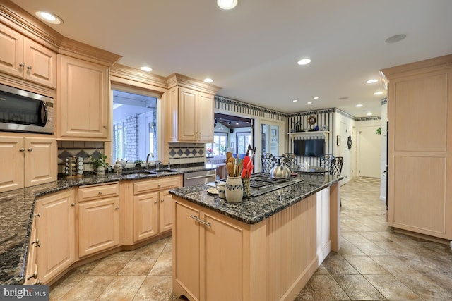 kitchen featuring tasteful backsplash, appliances with stainless steel finishes, light brown cabinetry, a sink, and recessed lighting