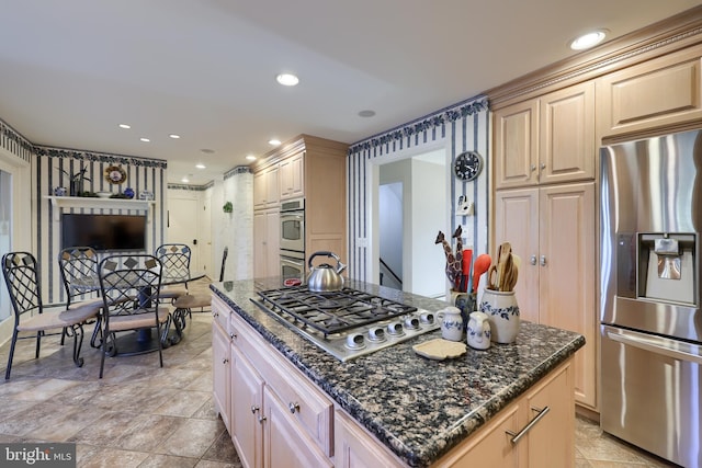 kitchen featuring stainless steel appliances, recessed lighting, and dark stone countertops