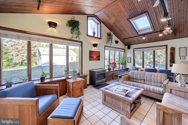 living area featuring a skylight, light tile patterned floors, wood ceiling, track lighting, and high vaulted ceiling