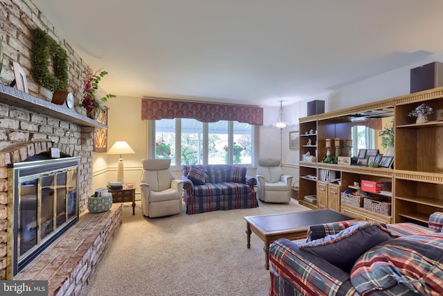 living room featuring carpet floors and a stone fireplace