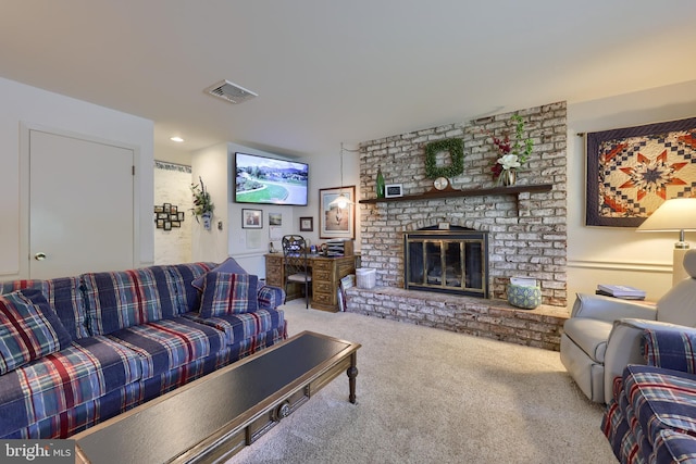 living area featuring a brick fireplace, carpet, and visible vents