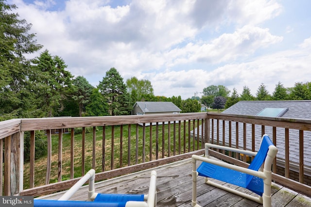 wooden deck featuring a yard